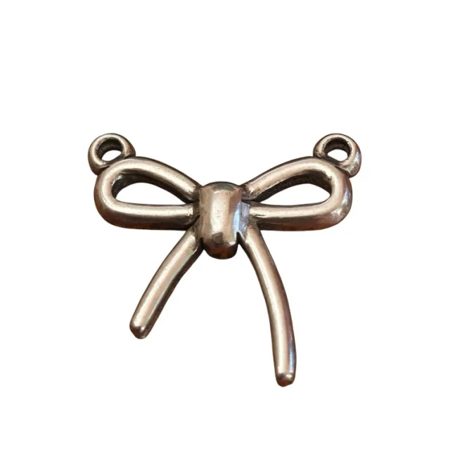 Antiqued bow connector with two top loops, 17mm in stainless steel